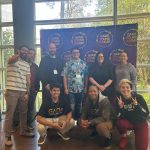 GADA speakers and members and other community members stand in front of a banner at Game Sound Summit