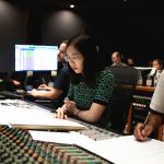 Scholar Yi-Fan Chen, Lead Composer at Bolero Game Studio, at a mixing console.
